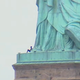 Image for article titled A Black Woman in Handcuffs For Climbing The Statue of Liberty on Independence Day is a Perfect Metaphor For America